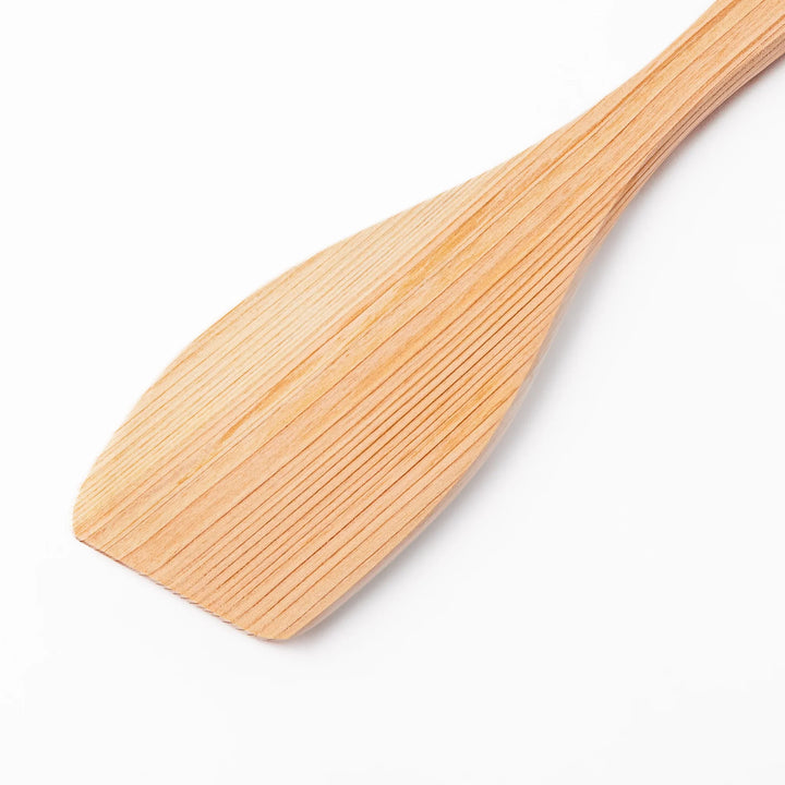 Compact hinoki wood spatula with a flat, angled edge and engraved handle, perfect for straining, flipping, and serving delicate dishes.