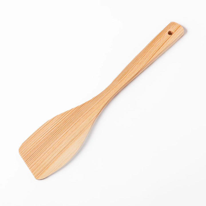 Compact hinoki wood spatula with a flat, angled edge and engraved handle, perfect for straining, flipping, and serving delicate dishes.