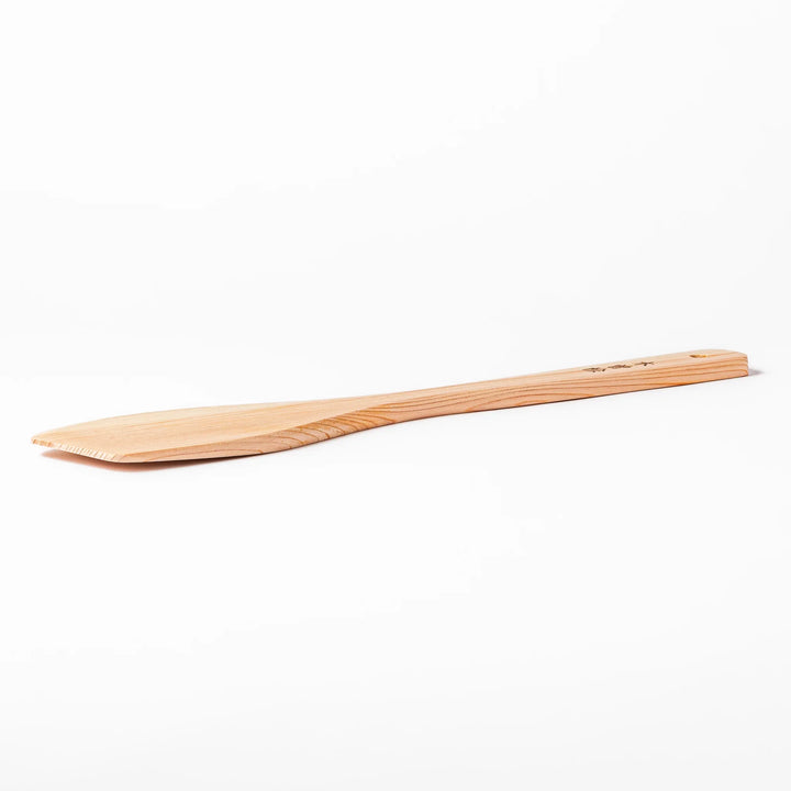 Compact hinoki wood spatula with a flat, angled edge and engraved handle, perfect for straining, flipping, and serving delicate dishes.