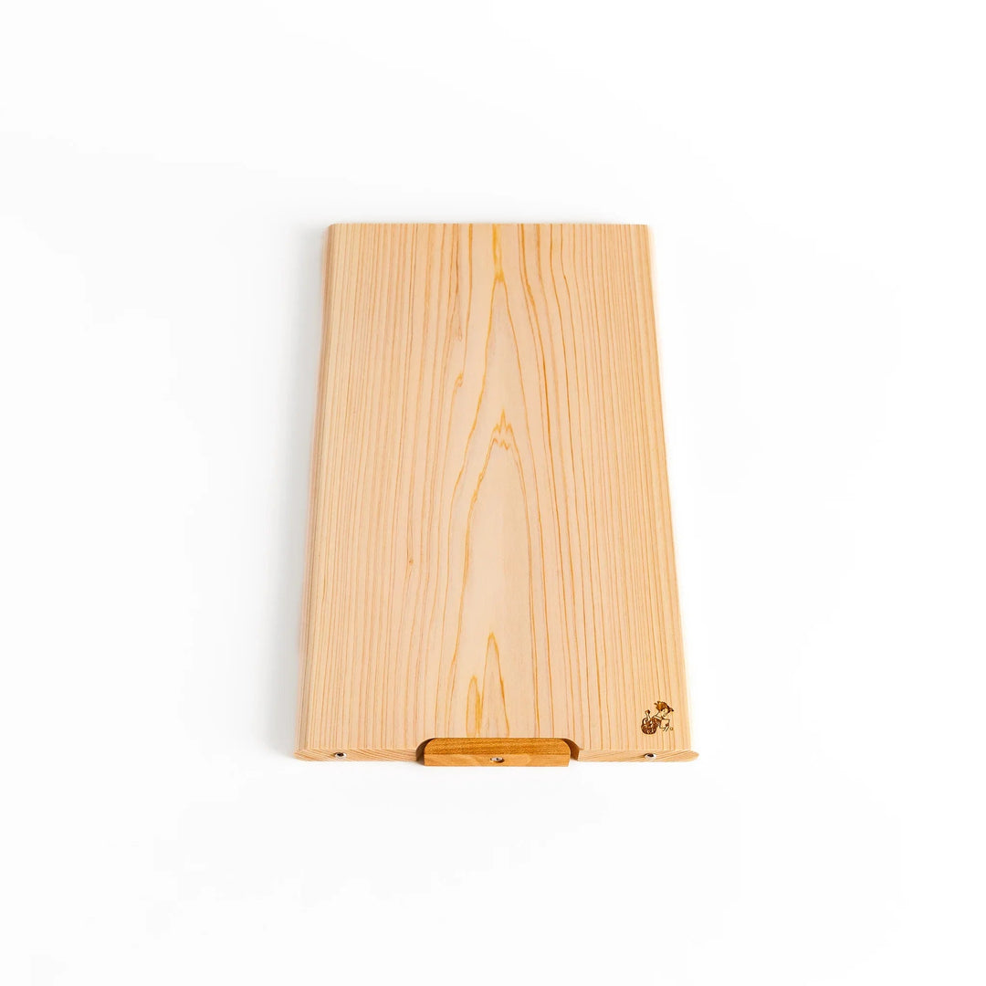 Hinoki wood cutting board with natural grain, engraved logo, and attached base for upright storage, combining beauty with everyday function.