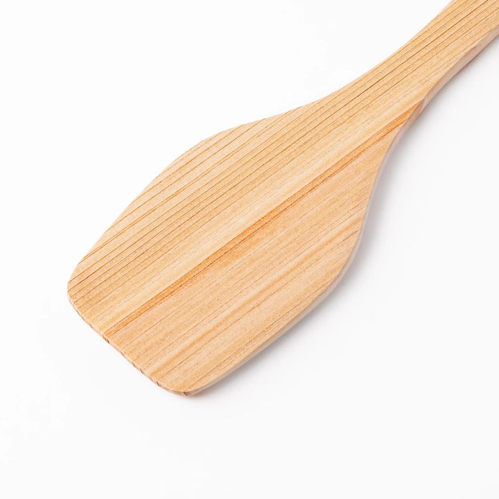 Compact hinoki wood spatula with a flat, angled edge and engraved handle, perfect for straining, flipping, and serving delicate dishes.