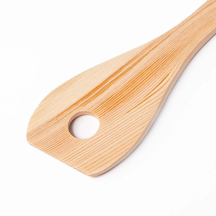 Hinoki wood slotted spatula with a circular cut-out and engraved handle, ideal for stirring and draining while adding a traditional Japanese touch.