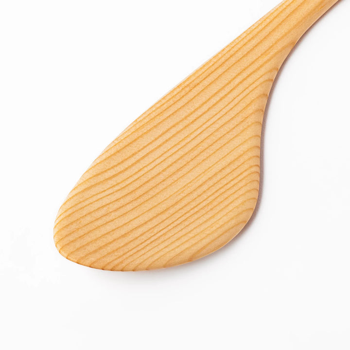 Curved spatula crafted from natural hinoki wood, featuring a wide paddle and smooth grain, perfect for stir-frying and gentle cooking tasks.