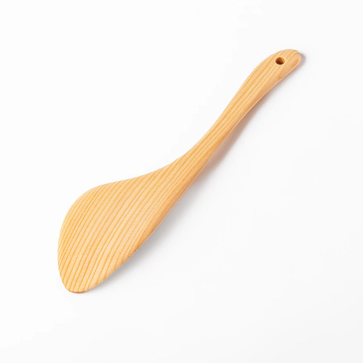 Curved spatula crafted from natural hinoki wood, featuring a wide paddle and smooth grain, perfect for stir-frying and gentle cooking tasks.