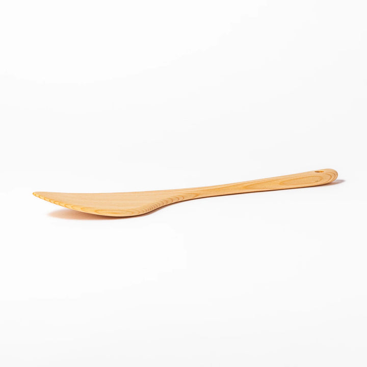 Curved spatula crafted from natural hinoki wood, featuring a wide paddle and smooth grain, perfect for stir-frying and gentle cooking tasks.