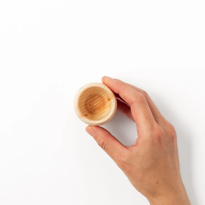 Hinoki wood sake set featuring one carafe and two cups, each adorned with an intricate burnt-in design, ideal for elevating traditional sake rituals.