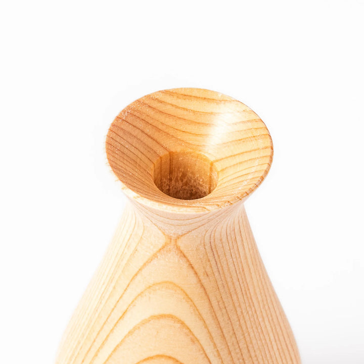 Hinoki wood sake set featuring one carafe and two cups, each adorned with an intricate burnt-in design, ideal for elevating traditional sake rituals.