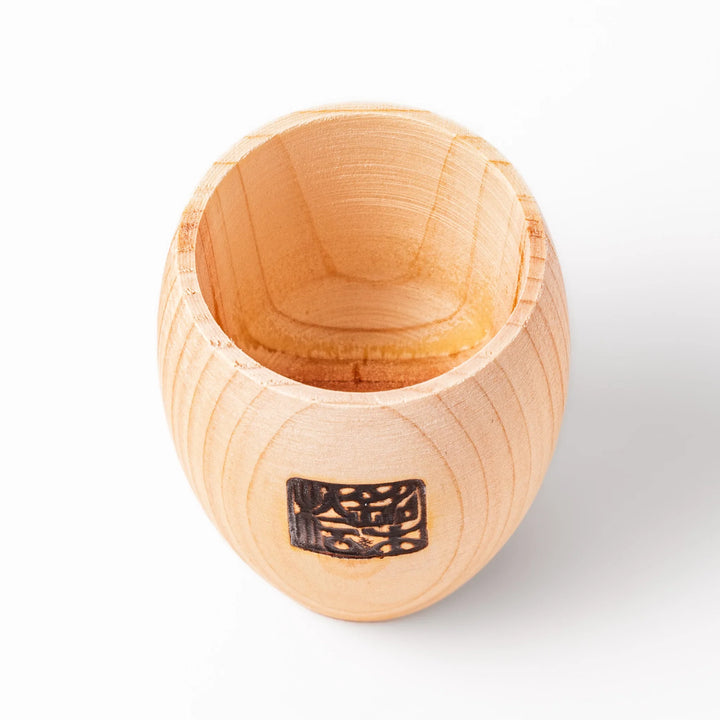 Hinoki wood sake set featuring one carafe and two cups, each adorned with an intricate burnt-in design, ideal for elevating traditional sake rituals.
