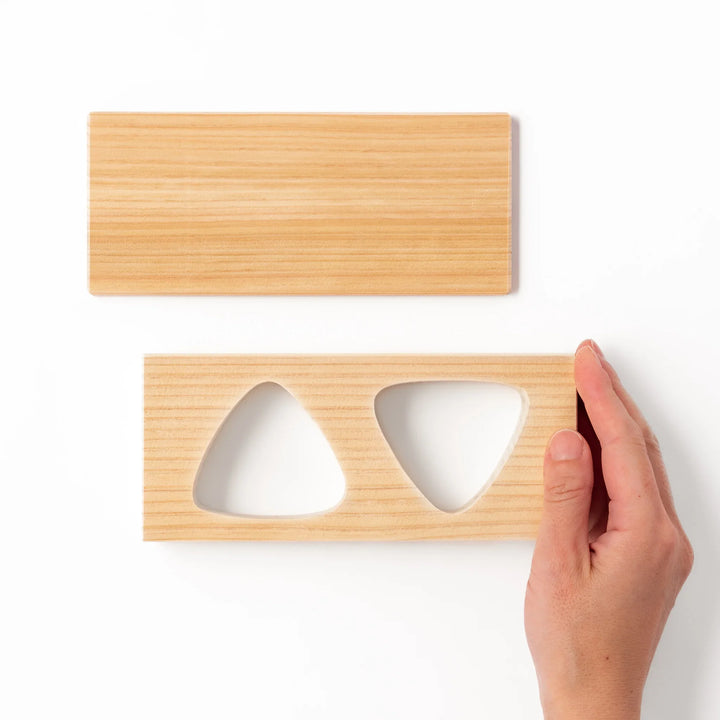 Hinoki wood onigiri mold with two triangle cavities and a matching lid, perfect for shaping traditional Japanese rice balls with ease and aroma.