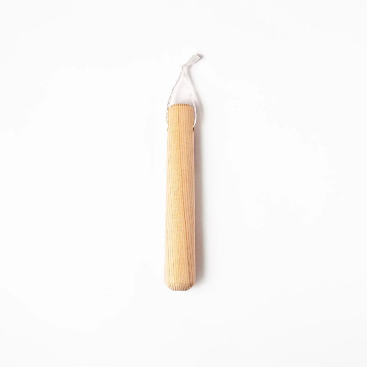 Hinoki wood pestle with engraved Japanese characters and hanging cord, crafted for use with suribachi mortars to grind seeds and spices smoothly.