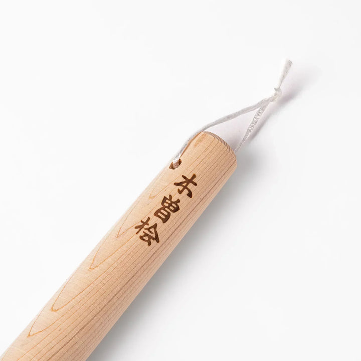 Hinoki wood pestle with engraved Japanese characters and hanging cord, crafted for use with suribachi mortars to grind seeds and spices smoothly.