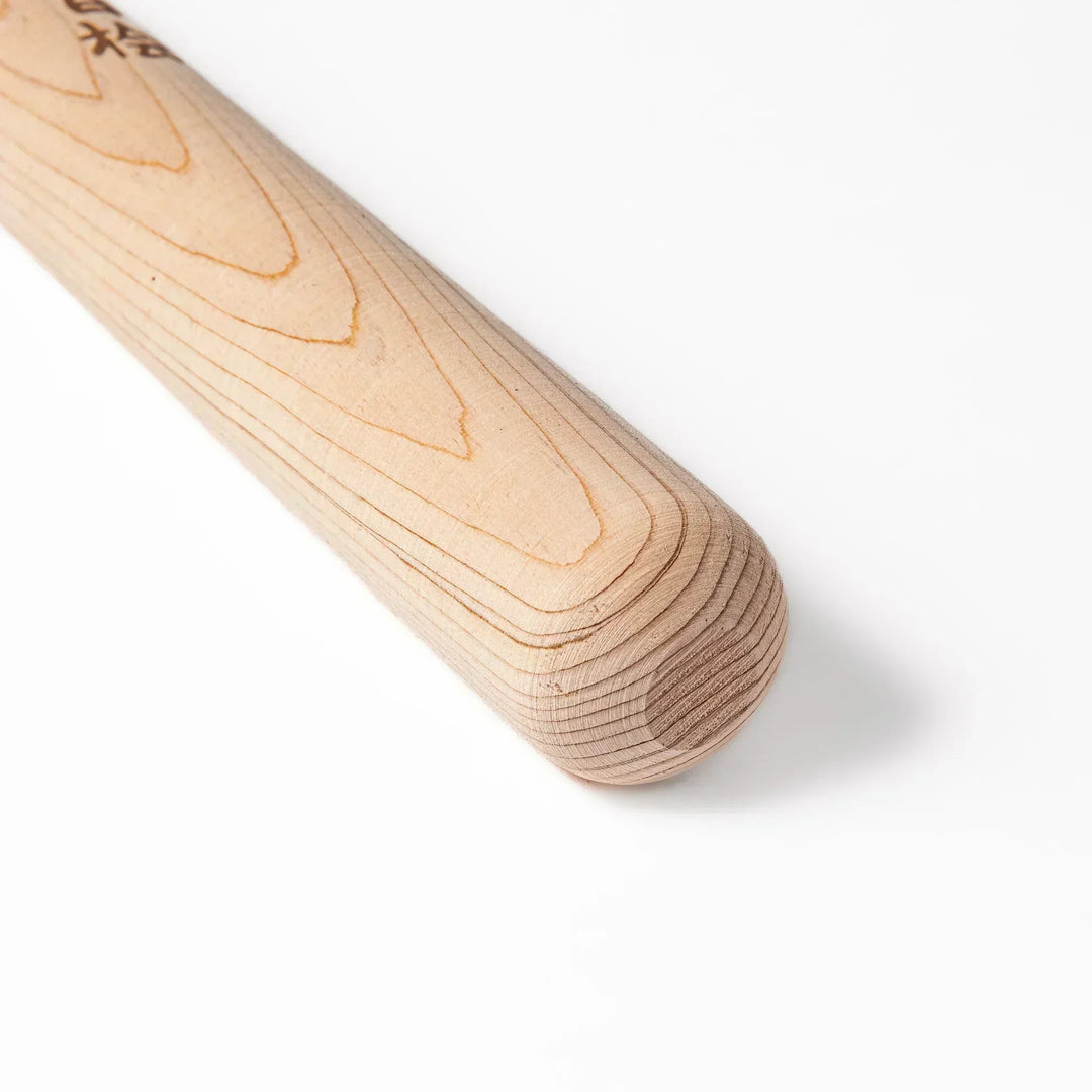 Hinoki wood pestle with engraved Japanese characters and hanging cord, crafted for use with suribachi mortars to grind seeds and spices smoothly.