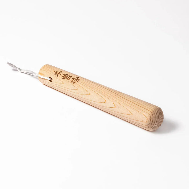Hinoki wood pestle with engraved Japanese characters and hanging cord, crafted for use with suribachi mortars to grind seeds and spices smoothly.