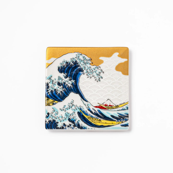 Square Japanese ceramic coaster featuring Hokusai’s Great Wave design with dramatic blue waves, golden sky, and Mt. Fuji, bringing iconic art to dining tables.