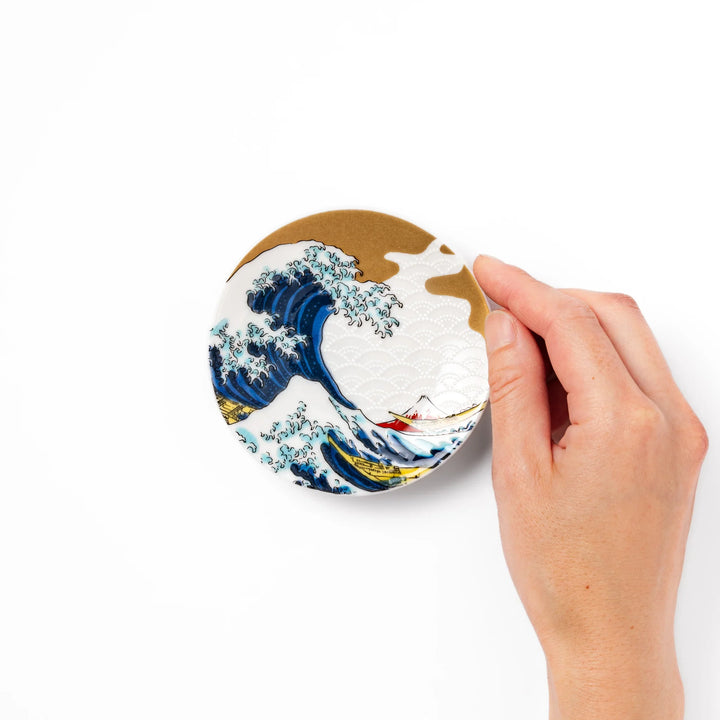 Round Japanese ceramic sauce dish featuring Hokusai’s Great Wave design with vivid blue waves, golden sky, and Mt. Fuji, perfect for soy sauce or condiments.