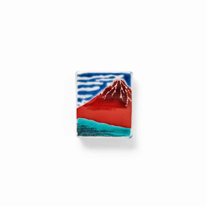 Rectangular Japanese ceramic chopstick rest featuring Hokusai’s Red Fuji design with vivid red mountain and blue sky, bringing iconic artistry to dining tables.