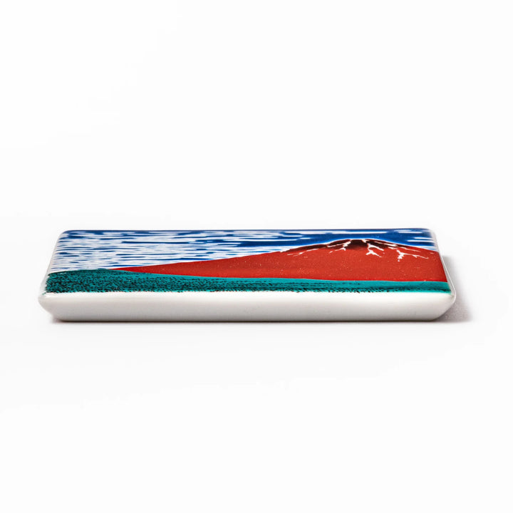Square Japanese ceramic coaster featuring Hokusai’s Red Fuji design with vivid red mountain, blue sky, and clouds, adding iconic artistry to dining tables.