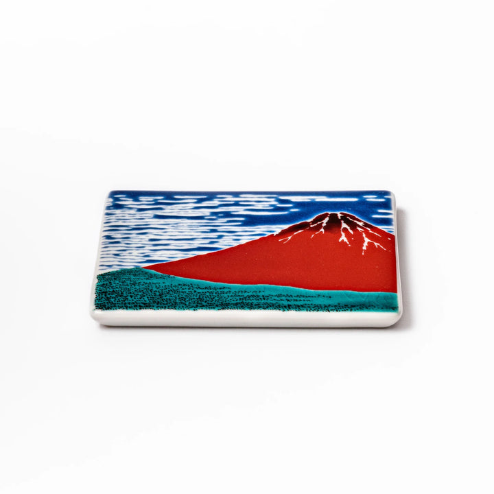 Square Japanese ceramic coaster featuring Hokusai’s Red Fuji design with vivid red mountain, blue sky, and clouds, adding iconic artistry to dining tables.