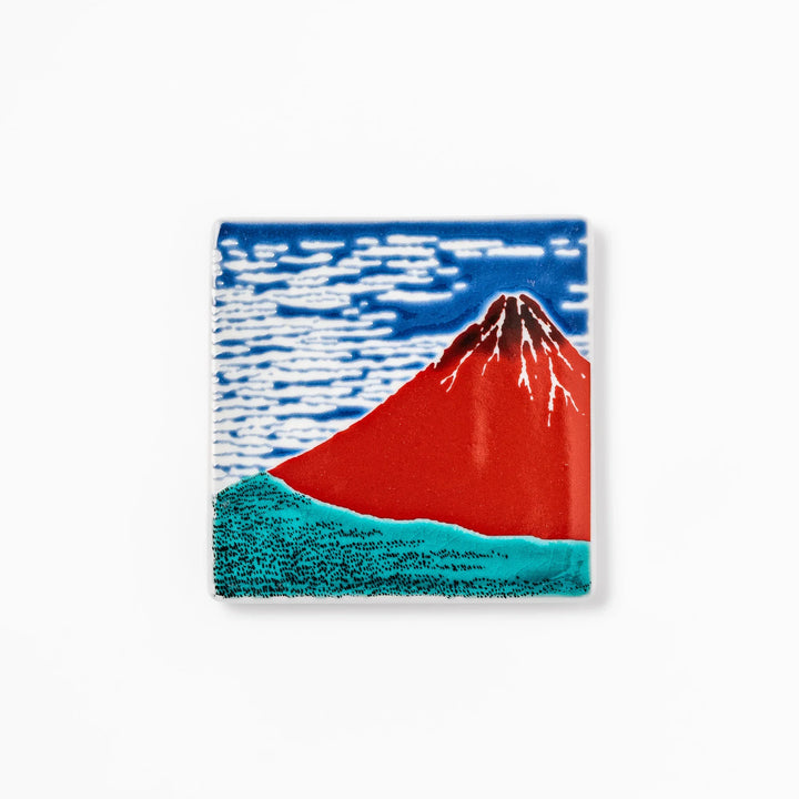 Square Japanese ceramic coaster featuring Hokusai’s Red Fuji design with vivid red mountain, blue sky, and clouds, adding iconic artistry to dining tables.