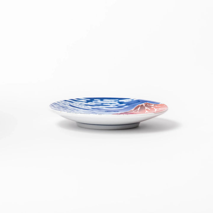 Round Japanese ceramic sauce dish featuring Hokusai’s iconic Red Fuji design with vivid red mountain, blue sky, and clouds, perfect for soy sauce or condiments.
