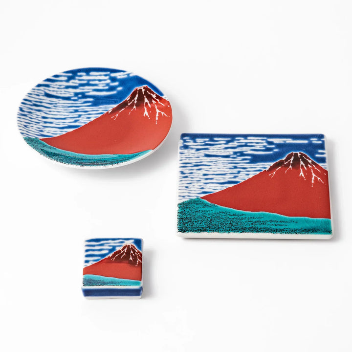 Japanese ceramic tableware set featuring Hokusai’s iconic Red Fuji design, including sauce dish, coaster, and chopstick rest, ideal for traditional dining.