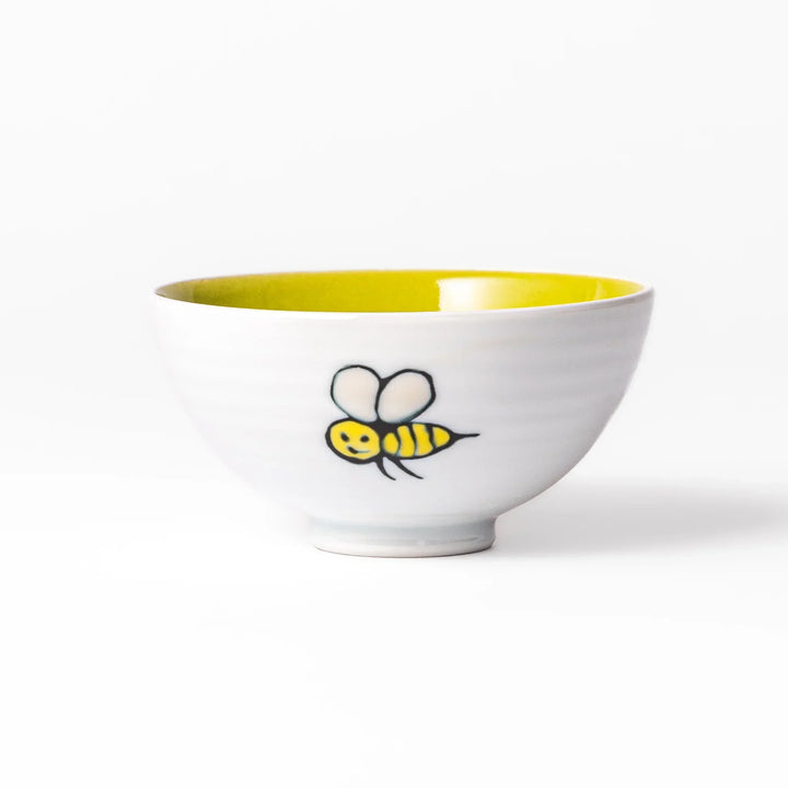 White ceramic kids rice bowl featuring honey bear face, chartreuse interior, round footed base