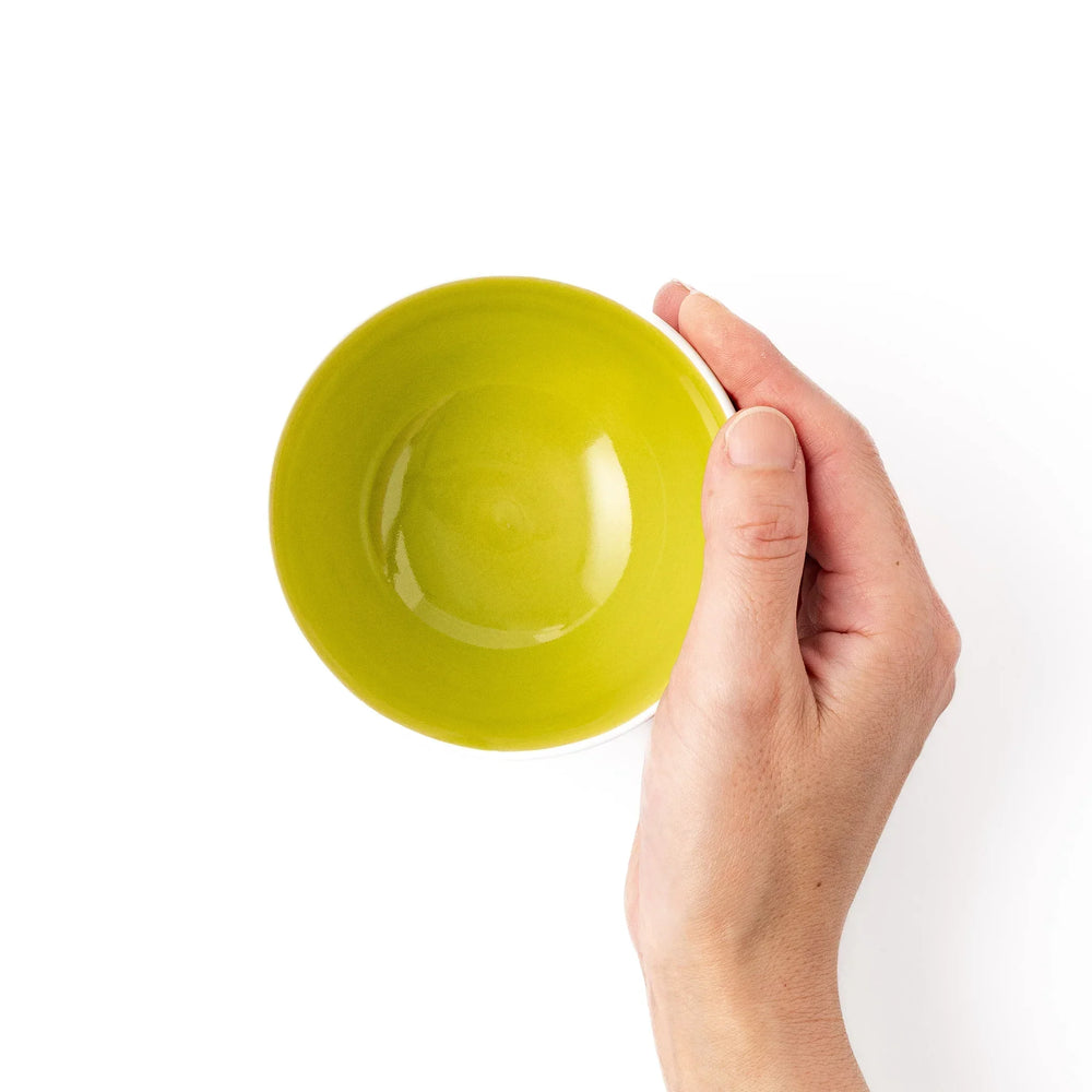 White ceramic kids rice bowl featuring honey bear face, chartreuse interior, round footed base