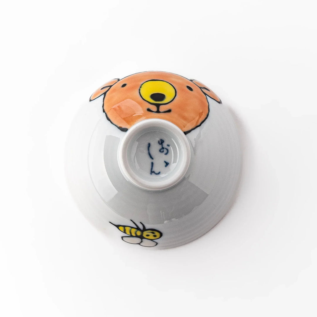 White ceramic kids rice bowl featuring honey bear face, chartreuse interior, round footed base