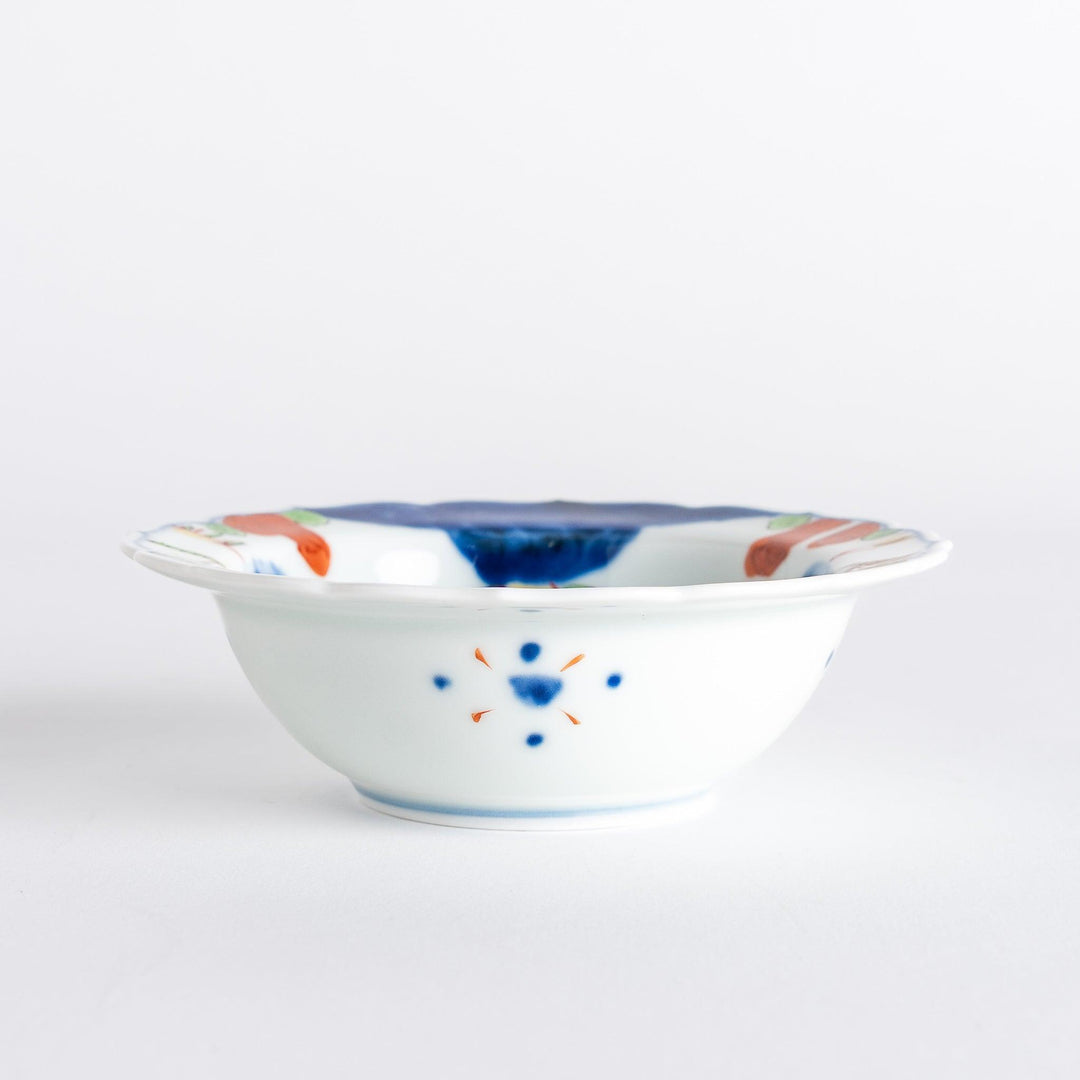 A small dessert bowl featuring colorful designs, including a galloping horse and abstract landscape motifs.
