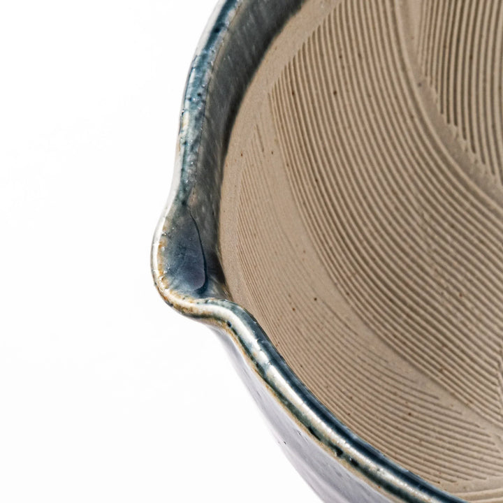 Indigo glaze Japanese suribachi mortar with cream-colored grooved interior and pouring spout, ideal for grinding sesame seeds, herbs, and spices.