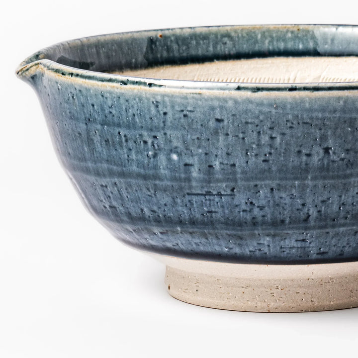 Indigo glaze Japanese suribachi mortar with cream-colored grooved interior and pouring spout, ideal for grinding sesame seeds, herbs, and spices.
