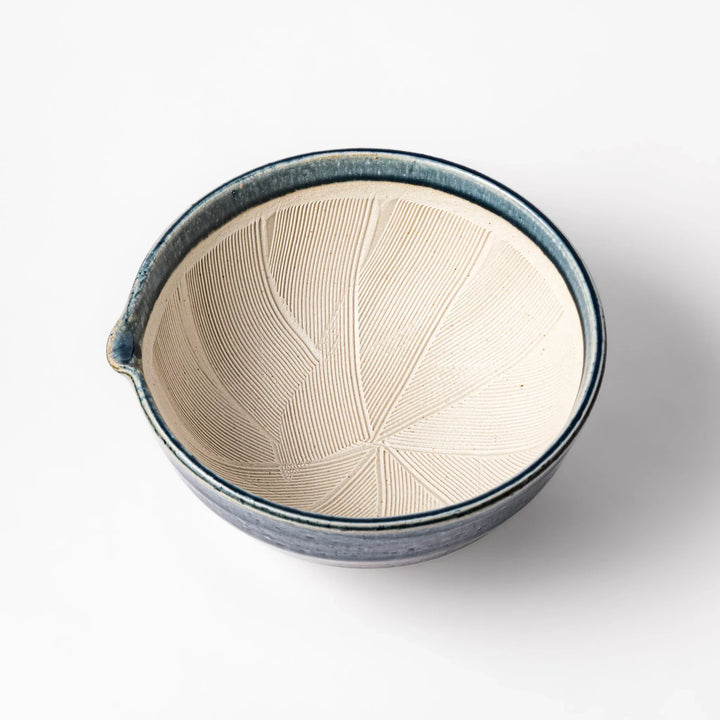 Indigo glaze Japanese suribachi mortar with cream-colored grooved interior and pouring spout, ideal for grinding sesame seeds, herbs, and spices.