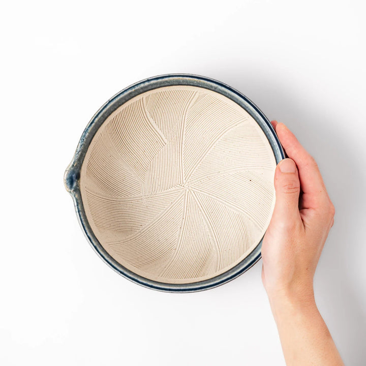 Indigo glaze Japanese suribachi mortar with cream-colored grooved interior and pouring spout, ideal for grinding sesame seeds, herbs, and spices.