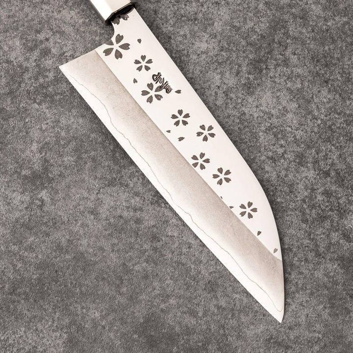 Elegant Japanese kitchen knife with cherry blossom cutout pattern on the blade, featuring a sharp edge and dark wooden handle for precise cutting.