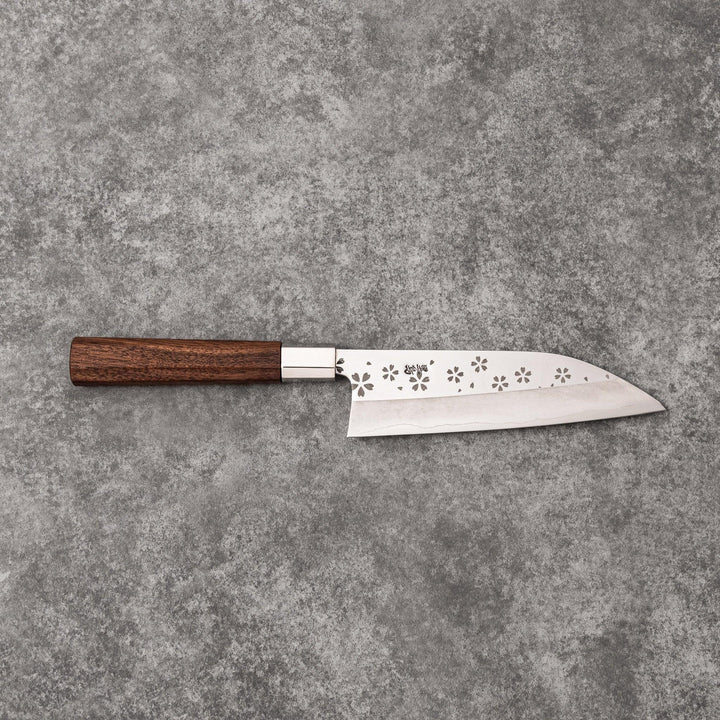Elegant Japanese kitchen knife with cherry blossom cutout pattern on the blade, featuring a sharp edge and dark wooden handle for precise cutting.
