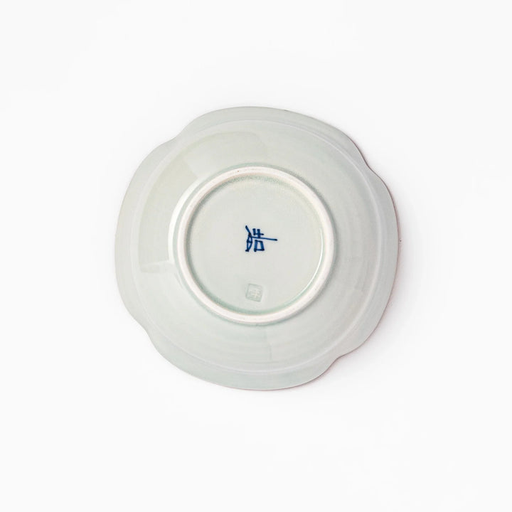 White ceramic cereal bowl with a scalloped rim, decorated inside with blue leaf motifs and a brown-accented edge.