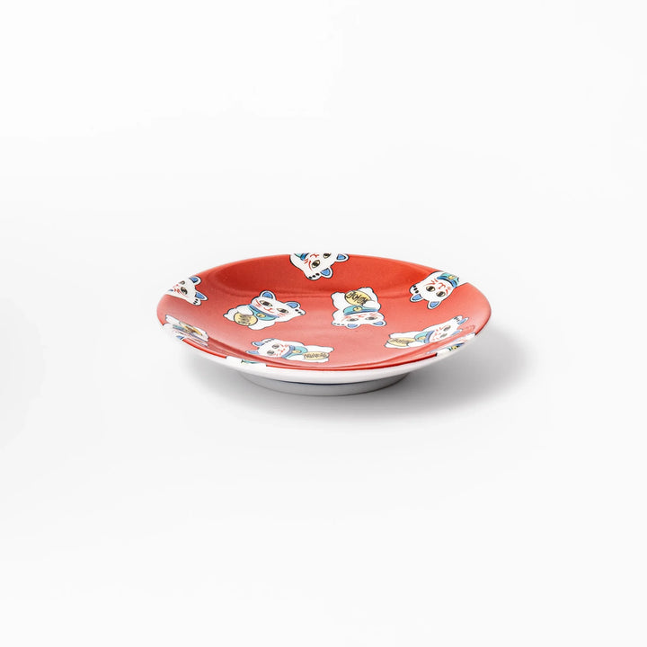 Round Japanese ceramic sauce dish with a red background decorated with playful maneki neko lucky cats, perfect for serving soy sauce or small condiments.