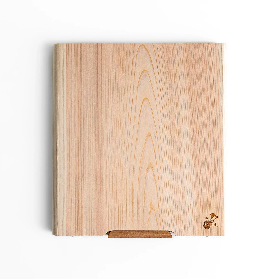 Medium Hinoki wood cutting board with natural grain, side handle, engraved motif, and smooth finish, crafted in Japan