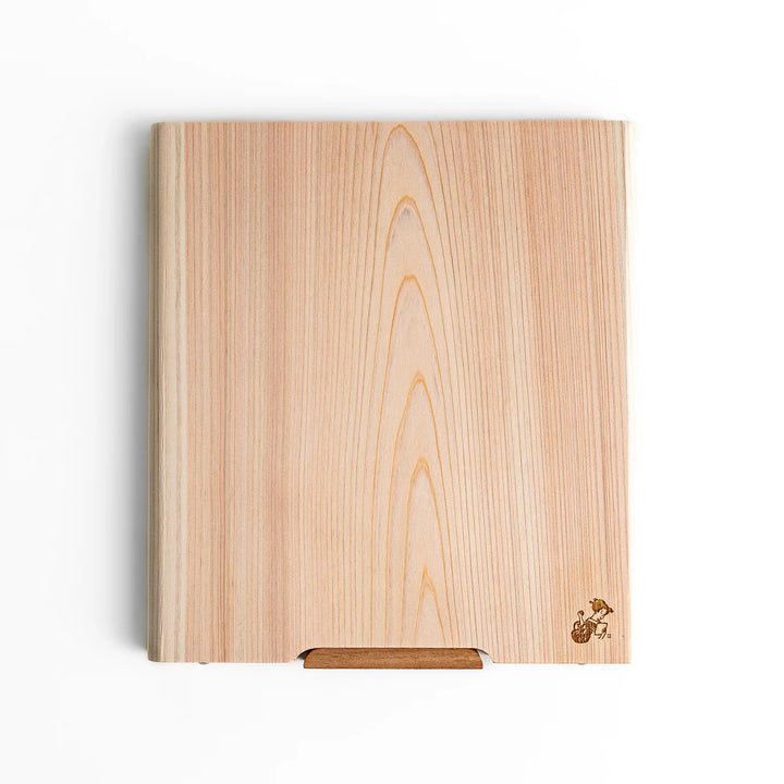Medium Hinoki wood cutting board with natural grain, side handle, engraved motif, and smooth finish, crafted in Japan