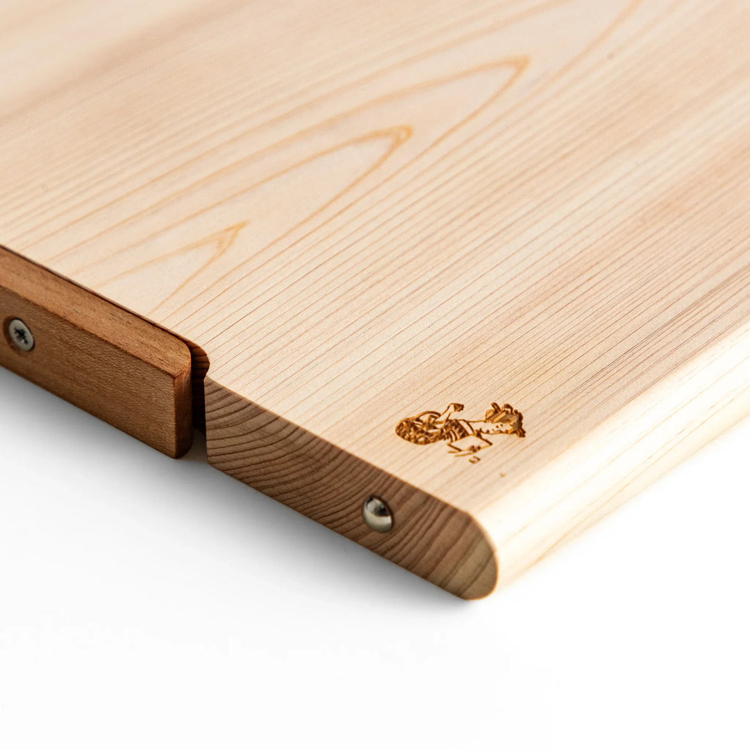 Medium Hinoki wood cutting board with natural grain, side handle, engraved motif, and smooth finish, crafted in Japan