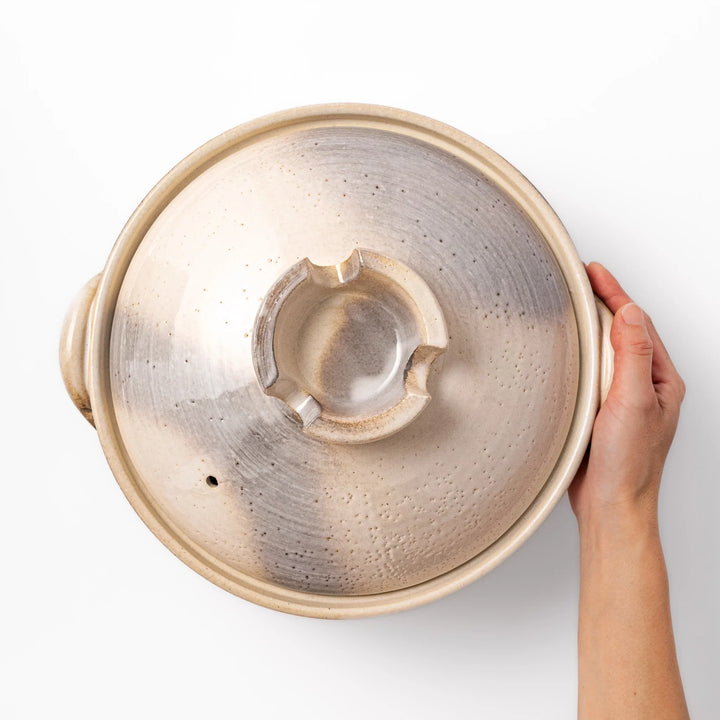 Japanese donabe clay pot with misty beige glazed lid and handles, family-size design ideal for hot pot and slow cooking meals.