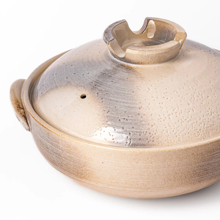Japanese donabe clay pot with misty beige glazed lid and handles, family-size design ideal for hot pot and slow cooking meals.