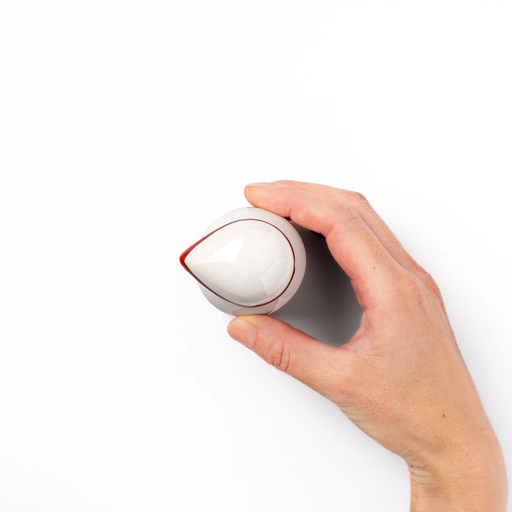 Japanese ceramic soy sauce dispenser with a red geometric pattern and moon rabbit motif, blending tradition and charm for an elegant dining table accent.