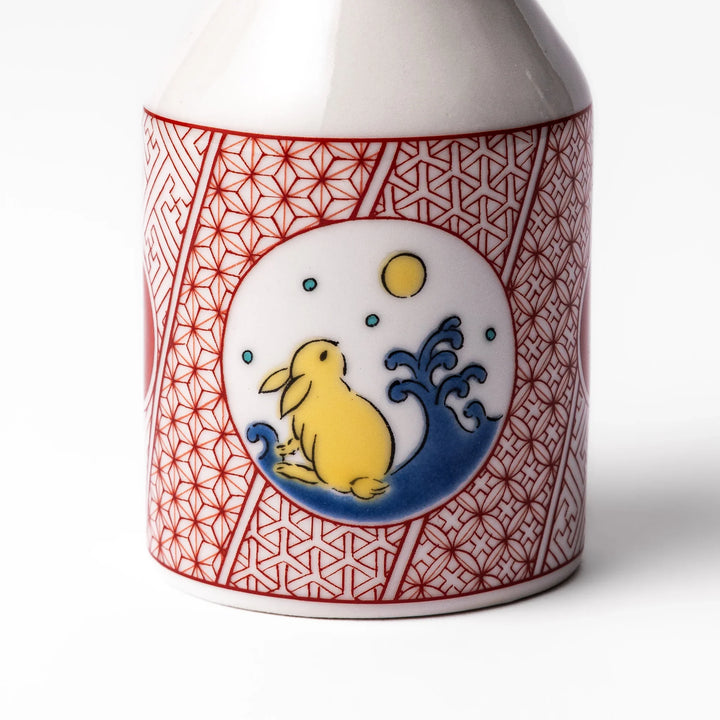 Japanese ceramic soy sauce dispenser with a red geometric pattern and moon rabbit motif, blending tradition and charm for an elegant dining table accent.