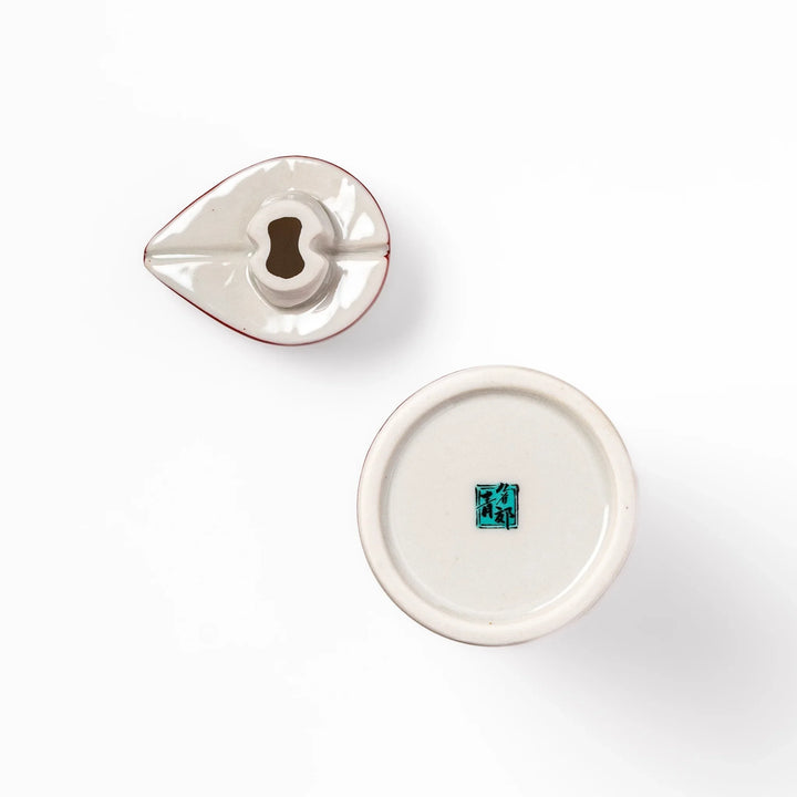 Japanese ceramic soy sauce dispenser with a red geometric pattern and moon rabbit motif, blending tradition and charm for an elegant dining table accent.