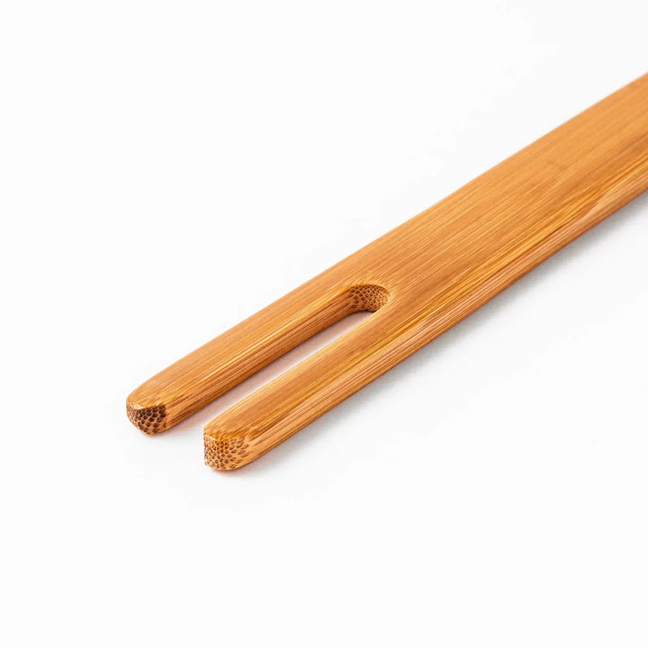 Bamboo natto stirring stick with a split-tip design and engraved Japanese text, ideal for mixing natto evenly and gently.