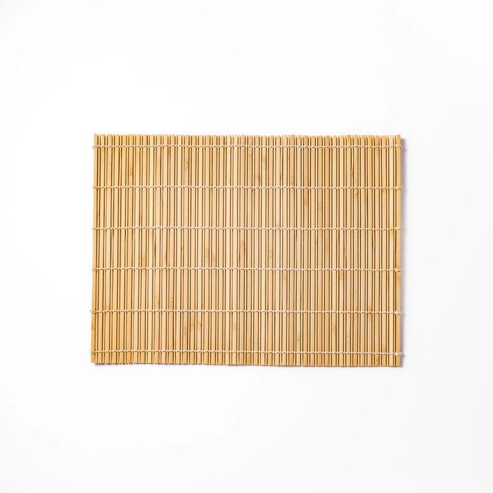 Natural finish bamboo table mat with slim vertical slats and white cord binding, offering a clean, earthy touch to traditional Japanese table settings.