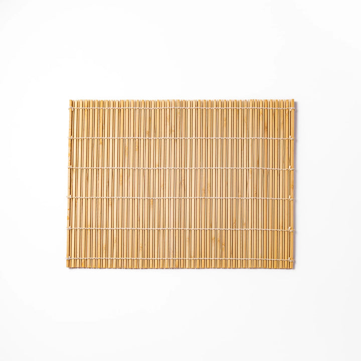 Natural finish bamboo table mat with slim vertical slats and white cord binding, offering a clean, earthy touch to traditional Japanese table settings.