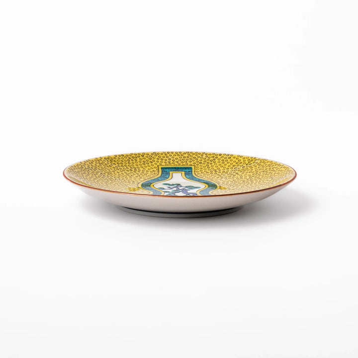 Japanese dessert plate featuring a yellow patterned background with a gourd-shaped center, showcasing a blue pine tree and green foliage.