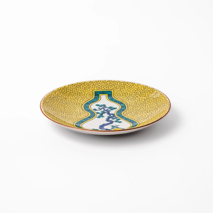 Japanese dessert plate featuring a yellow patterned background with a gourd-shaped center, showcasing a blue pine tree and green foliage.